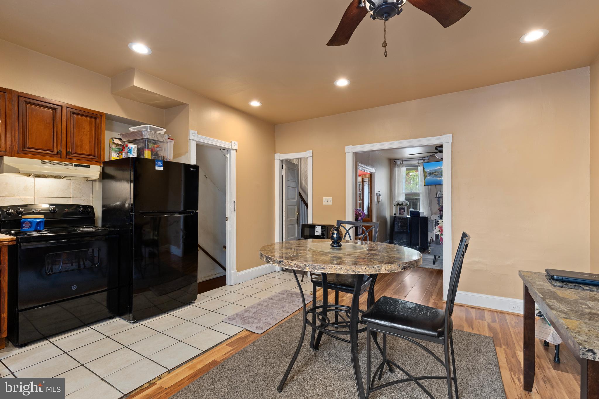 619 Columbia Road Northwest Washington, DC 20001 - Photo 12 of 29 a kitchen with stainless steel appliances kitchen island granite countertop dining table chairs and a refrigerator