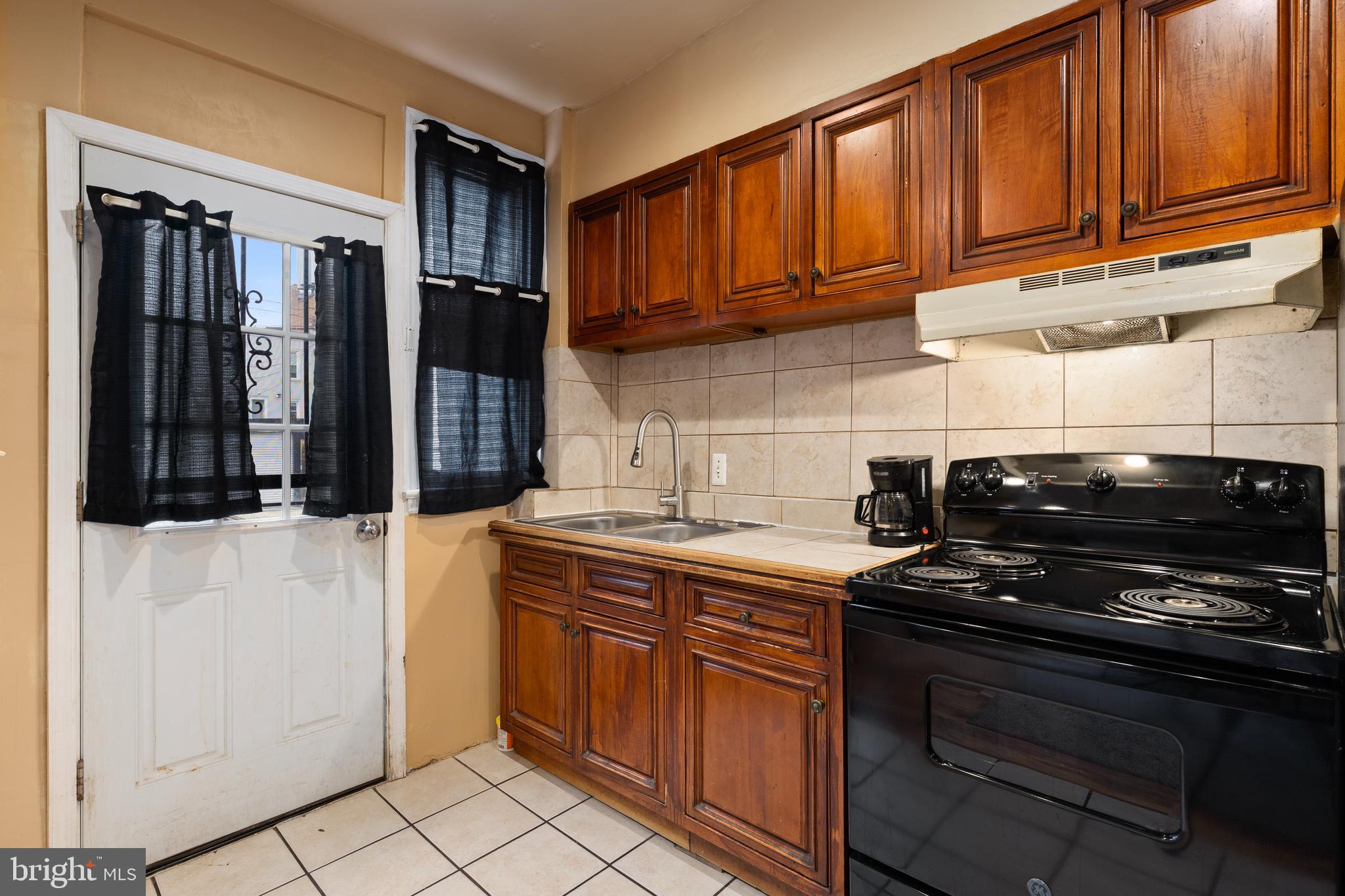 619 Columbia Road Northwest Washington, DC 20001 - Photo 13 of 29 a kitchen with stainless steel appliances granite countertop a stove a sink and a microwave