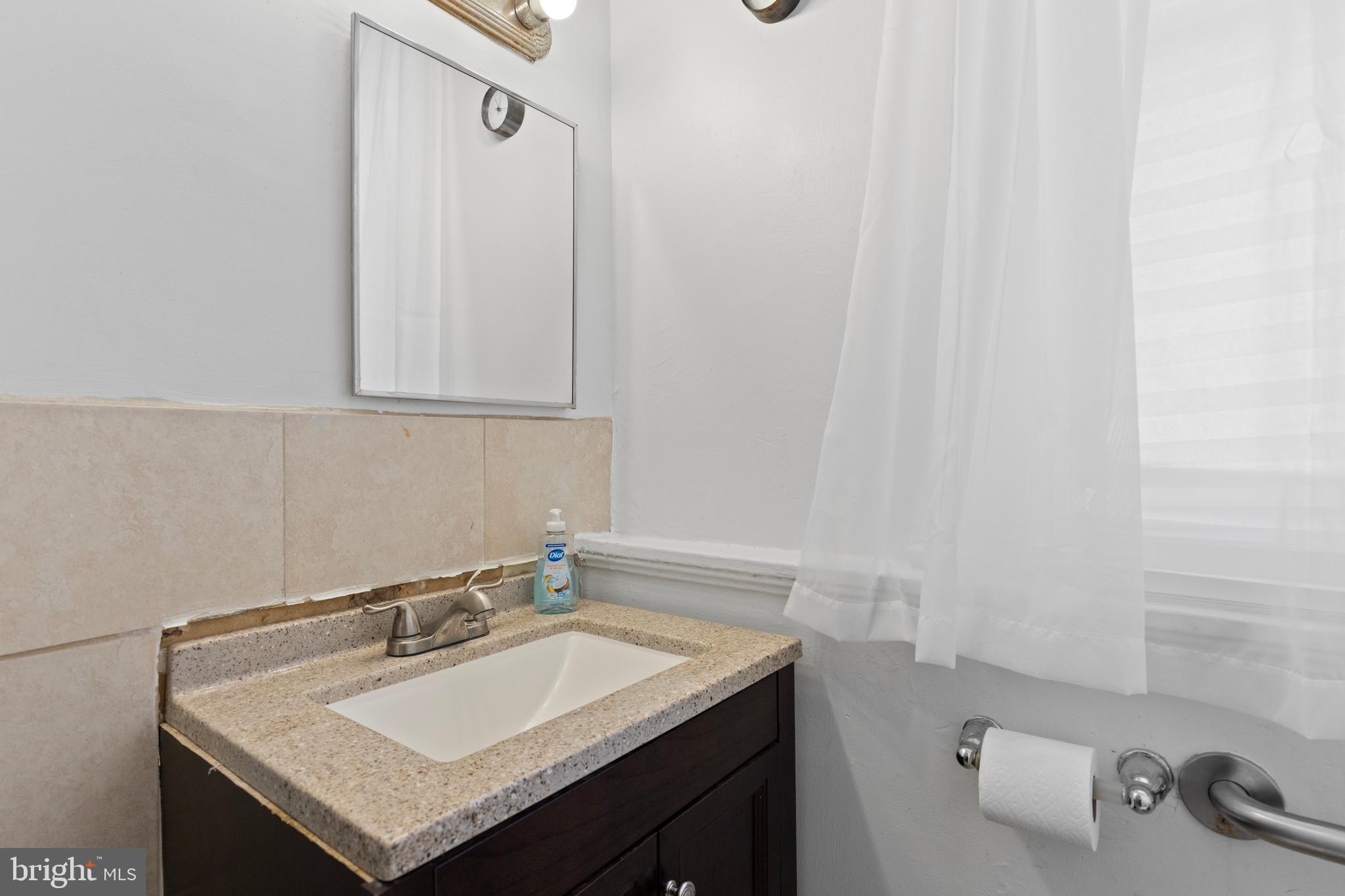619 Columbia Road Northwest Washington, DC 20001 - Photo 15 of 29 a bathroom with a sink and a vanity