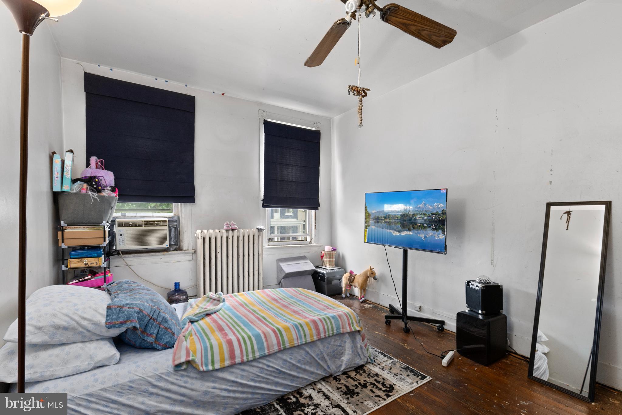 619 Columbia Road Northwest Washington, DC 20001 - Photo 19 of 29 a bedroom with two beds and a flat screen tv