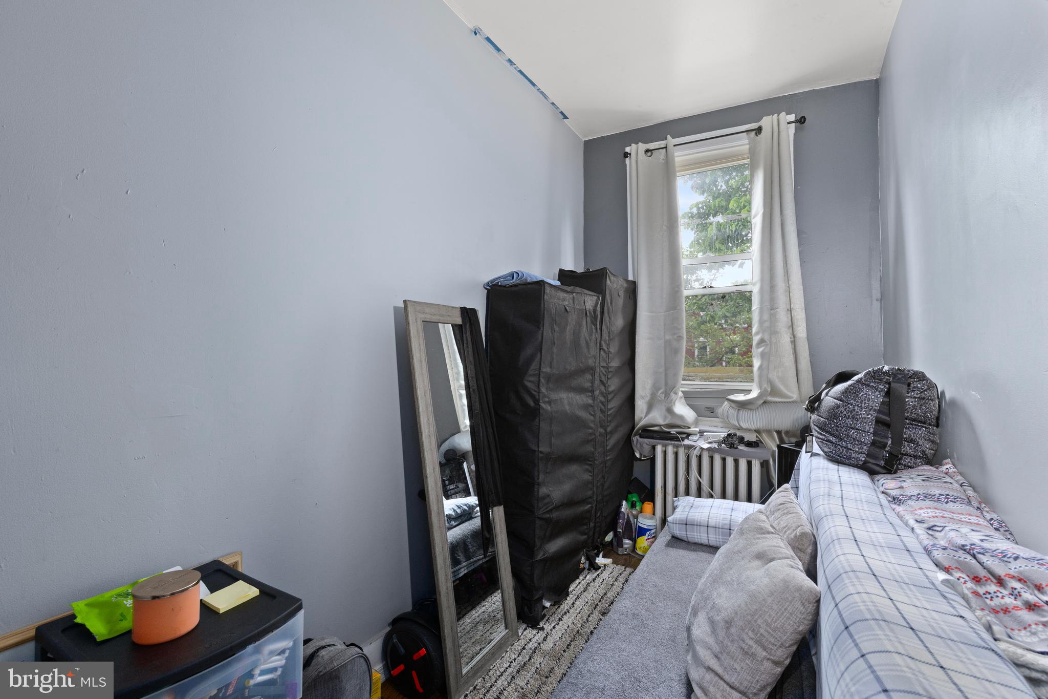 619 Columbia Road Northwest Washington, DC 20001 - Photo 23 of 29 a bedroom with a bed and a window