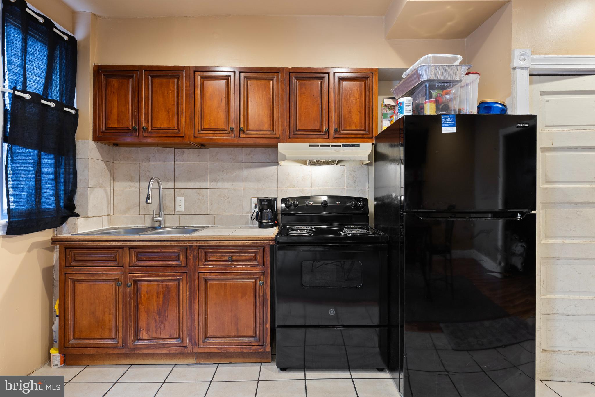 619 Columbia Road Northwest Washington, DC 20001 - Photo 5 of 29 a kitchen with a refrigerator and cabinets