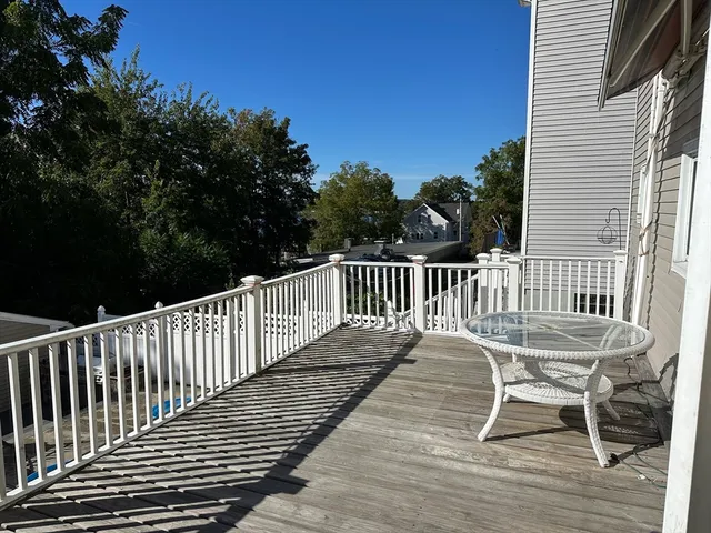 a view of a chair and table on the deck