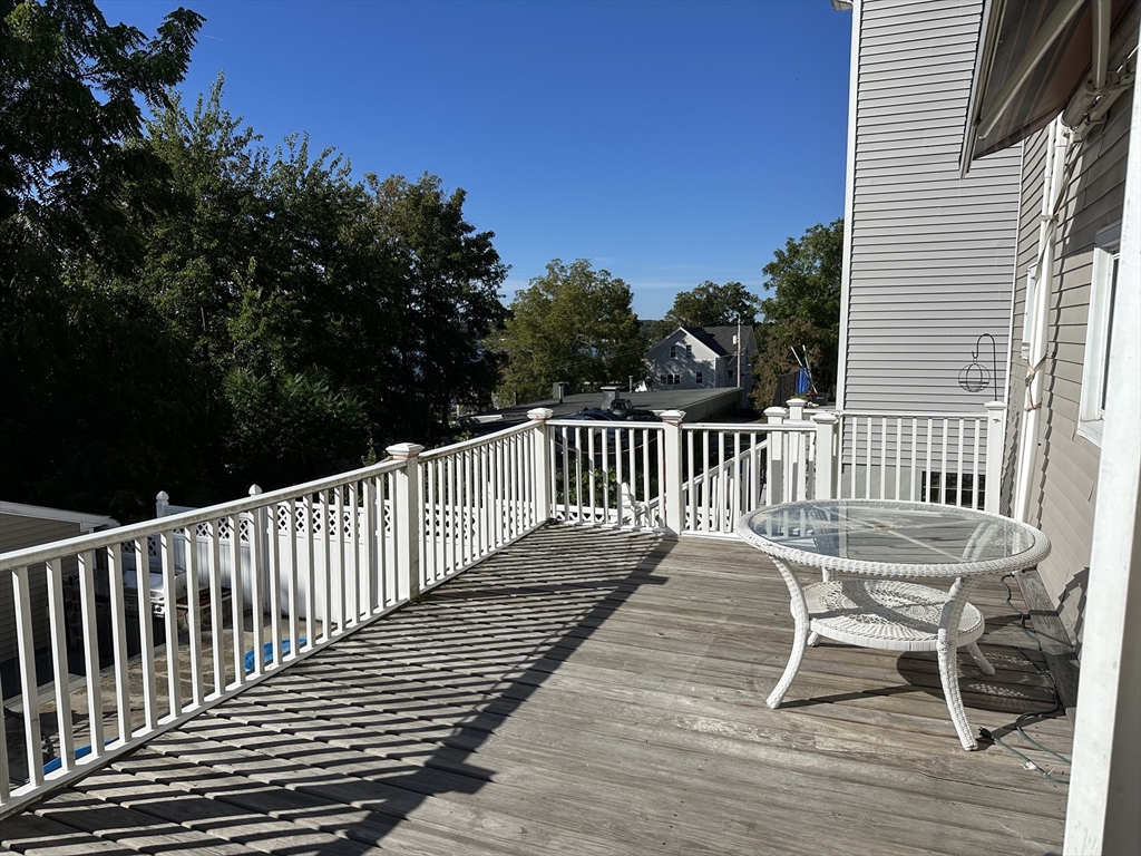 396 Durfee Street, Unit 1 Fall River, MA 02720 - Photo 12 of 13 a view of a chair and table on the deck