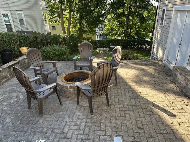 a view of backyard with outdoor seating and trees