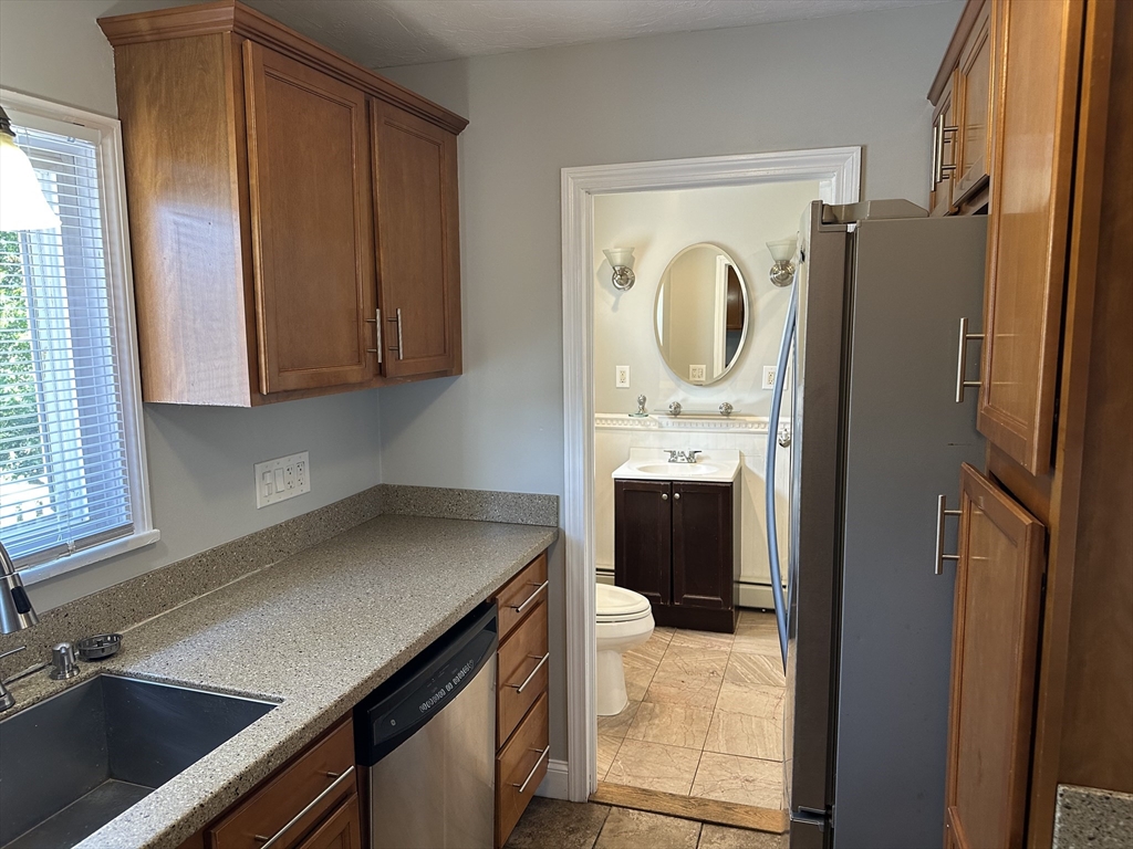 396 Durfee Street, Unit 1 Fall River, MA 02720 - Photo 6 of 13 a kitchen with a refrigerator sink and cabinets