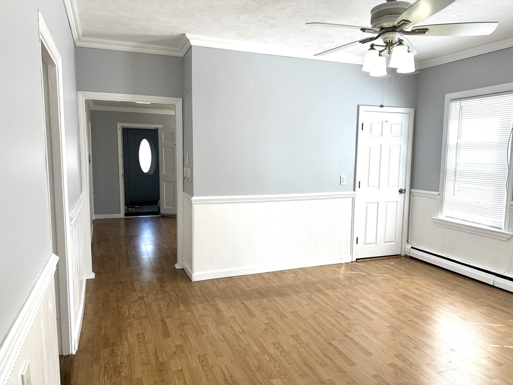 396 Durfee Street, Unit 1 Fall River, MA 02720 - Photo 8 of 13 wooden floor in an empty room with a window
