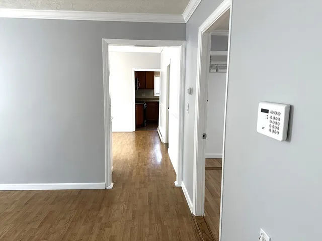 a view of a hallway with wooden floor