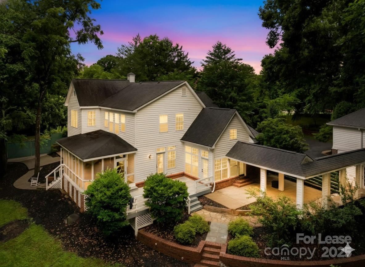 a front view of a house with a yard and potted plants