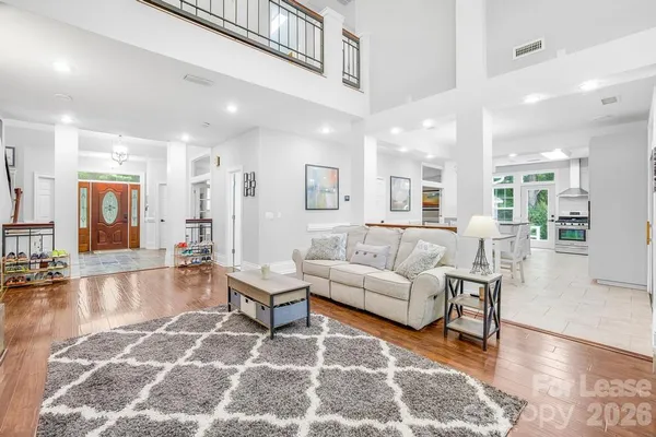 a kitchen with stainless steel appliances granite countertop a stove a refrigerator a oven a sink with a dining table and chairs