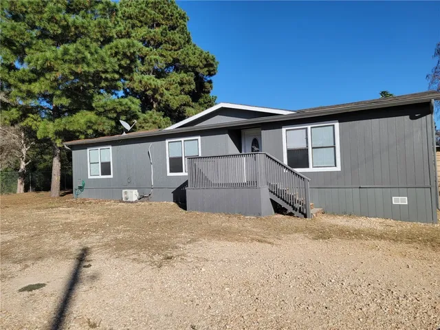 a house with trees in the background