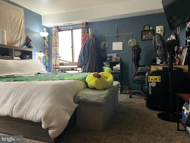 a living room with a couch and dresser