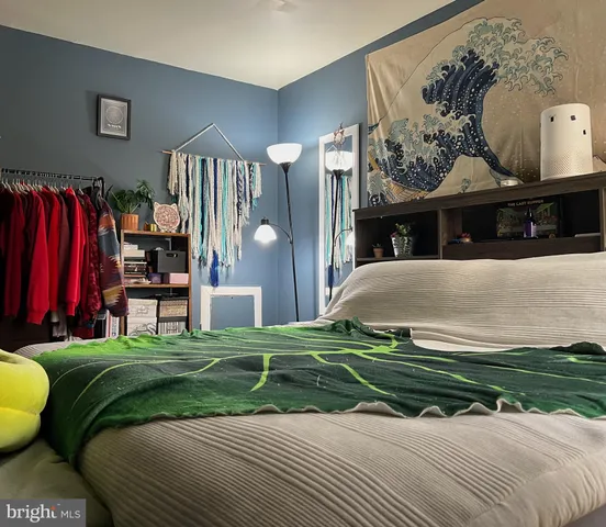 a view of a brick house with many windows next to a yard