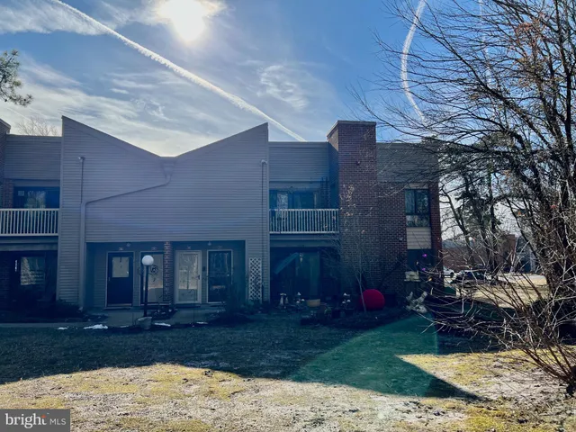 a front view of a house with parking space