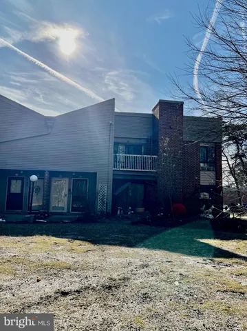 a view of a house with snow on the side of the road