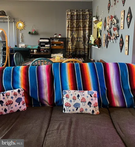 a living room with furniture and lamp