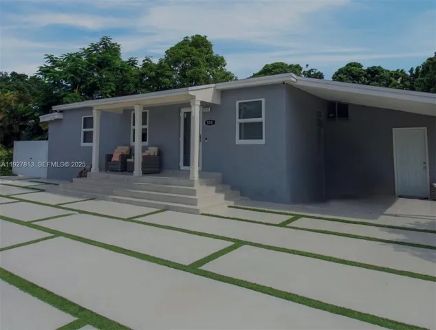 a house that has a tree in front of it