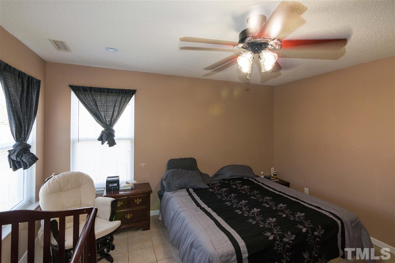 3613 Croydon Mill Way Raleigh, NC 27616 - Photo 11 of 19 a bedroom with a bed window and a chandelier