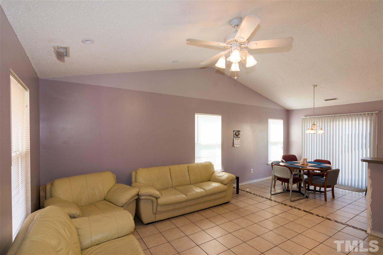3613 Croydon Mill Way Raleigh, NC 27616 - Photo 5 of 19 a living room with furniture a chandelier and a window