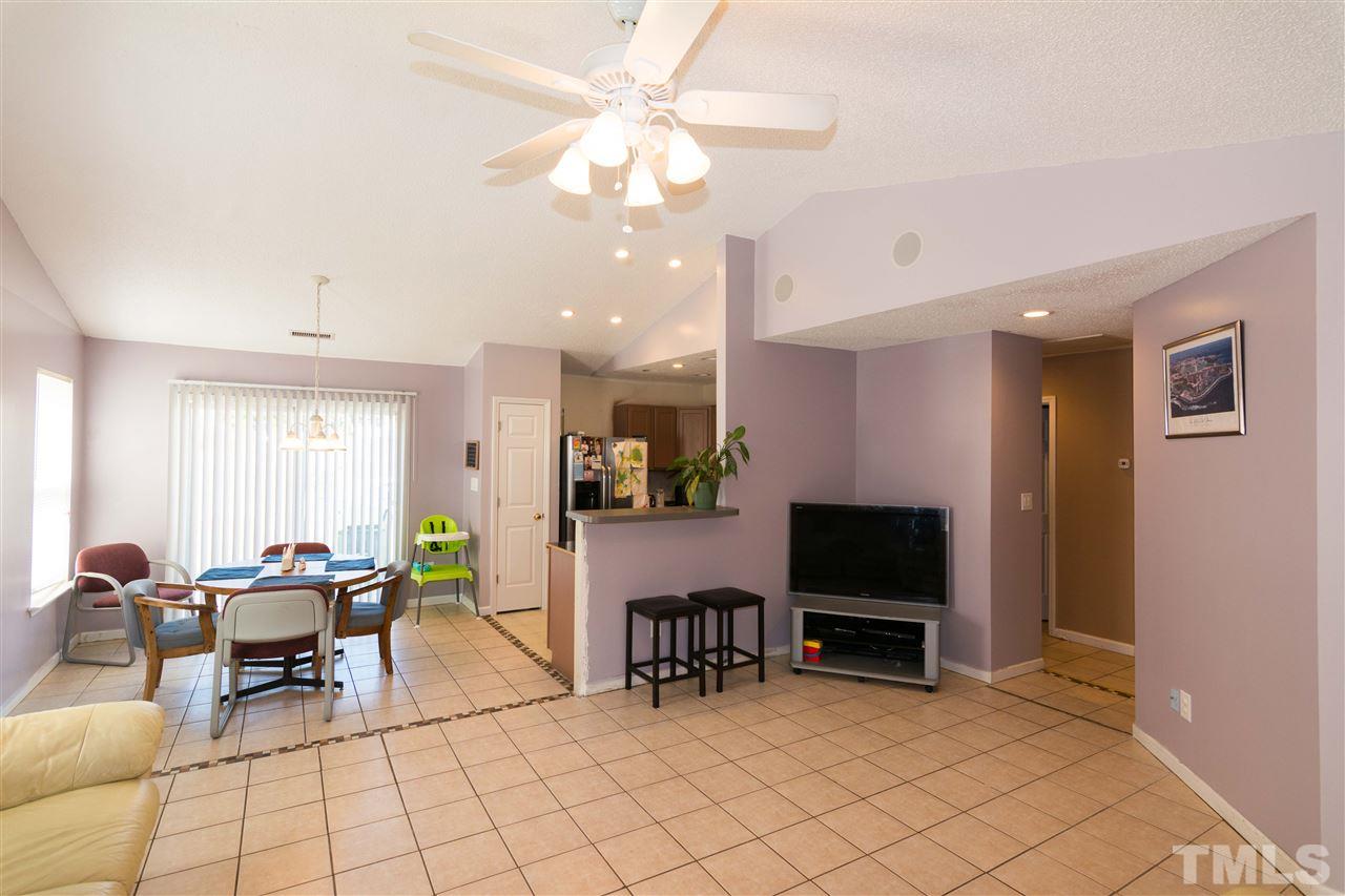 3613 Croydon Mill Way Raleigh, NC 27616 - Photo 6 of 19 a living room with furniture a flat screen tv and a refrigerator