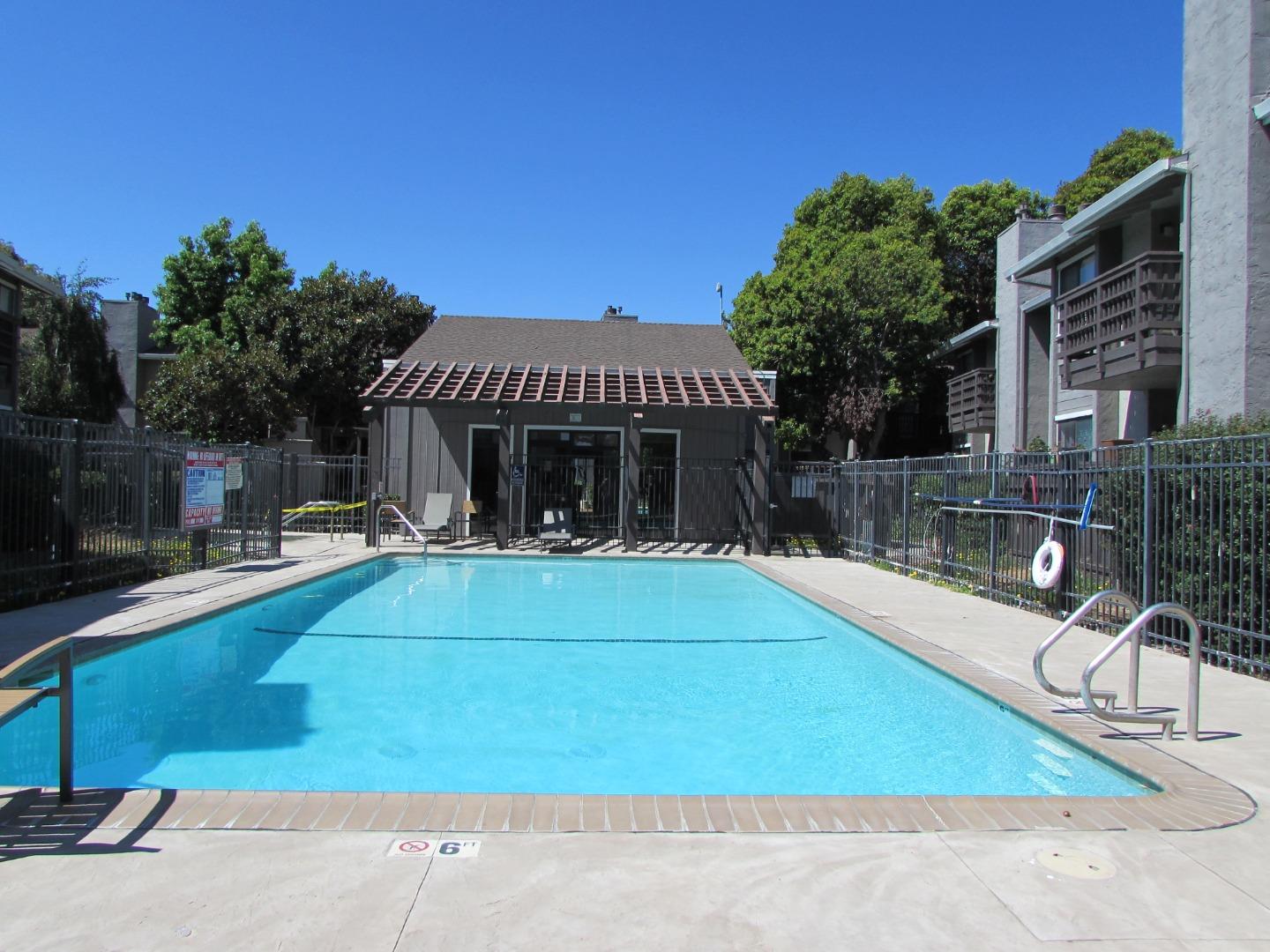 a view of a house with swimming pool and sitting area