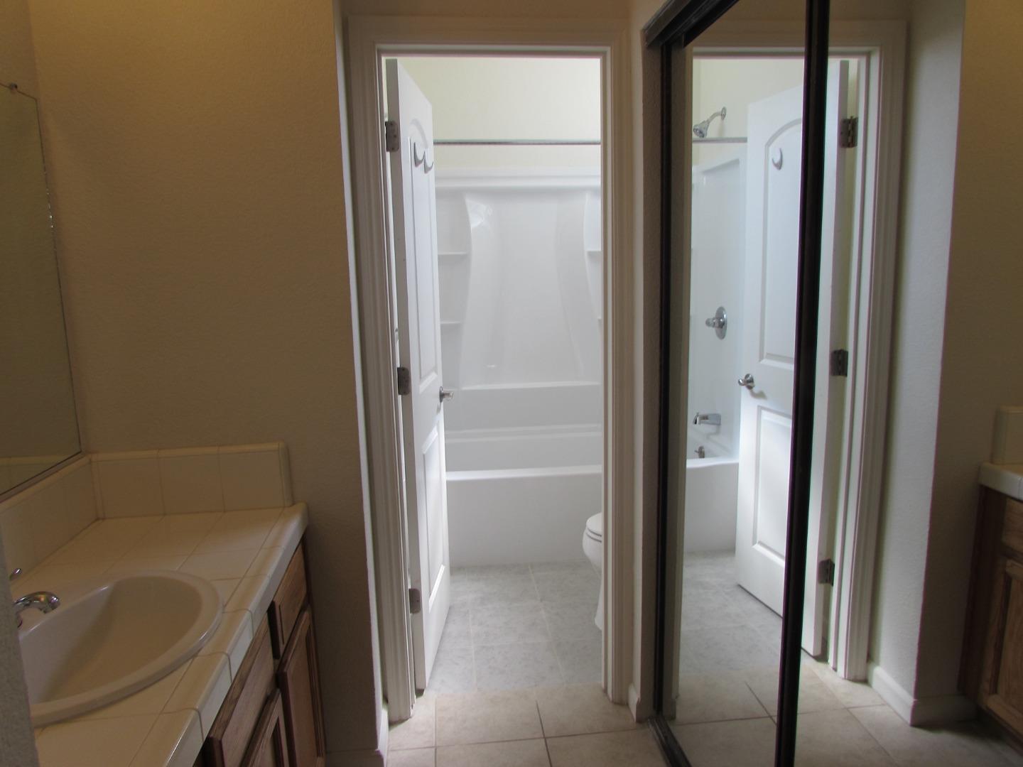 409 Tyler Place, Unit B Salinas, CA 93906 - Photo 11 of 25 a bathroom with a tub and shower
