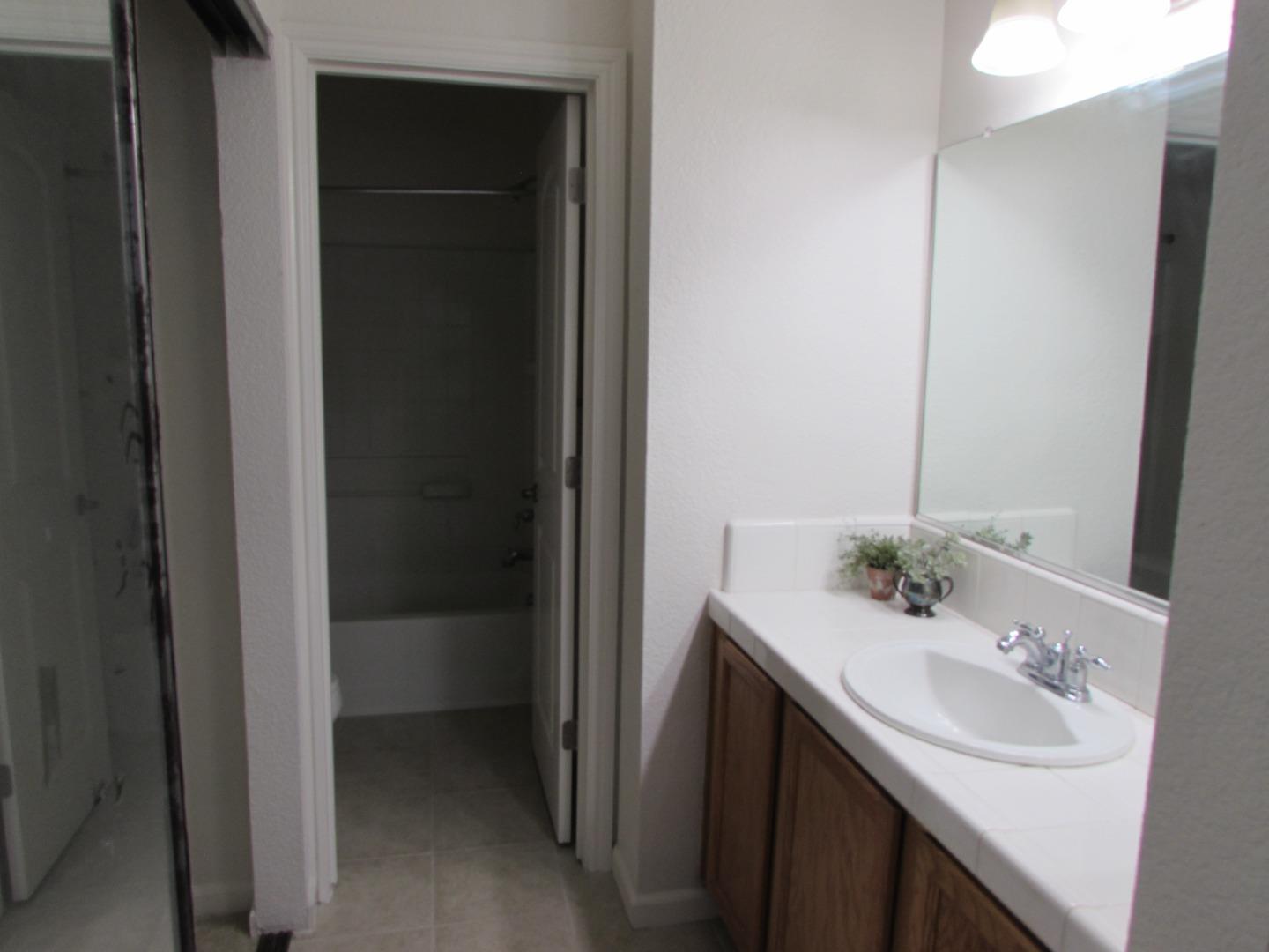 409 Tyler Place, Unit B Salinas, CA 93906 - Photo 12 of 25 a bathroom with a sink and a mirror