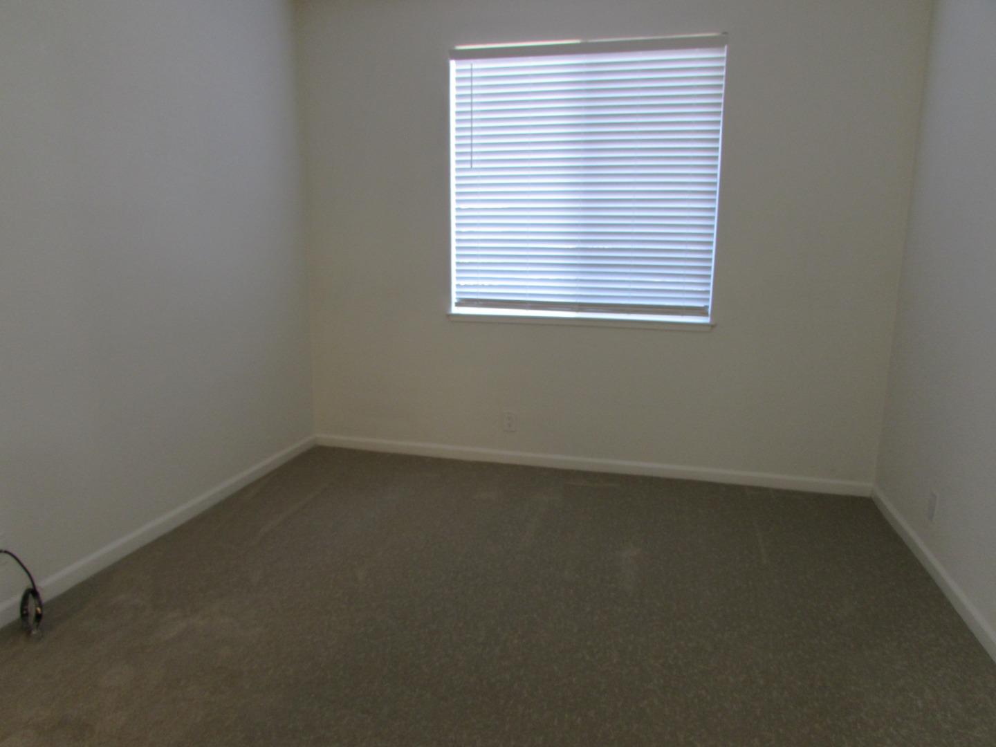 409 Tyler Place, Unit B Salinas, CA 93906 - Photo 15 of 25 an empty room with a window