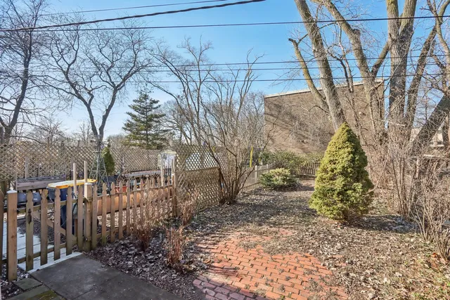 a view of a yard with wooden fence