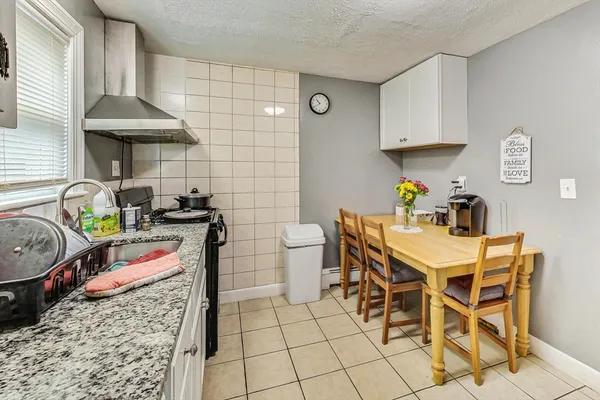 a kitchen with stainless steel appliances granite countertop a sink and a stove top oven