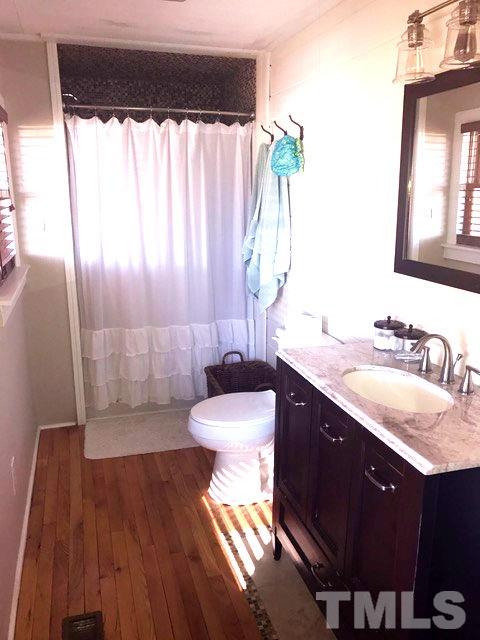 5349 Range Road Rougemont, NC 27572 - Photo 12 of 19 a bathroom with a granite countertop sink toilet and shower