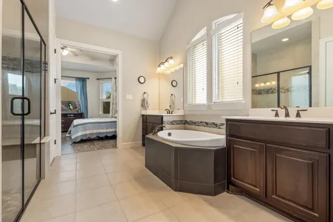 a spacious bathroom with a double vanity sink mirror and double
