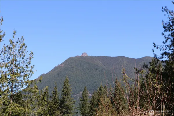 a view of a large mountain with a mountain in the background