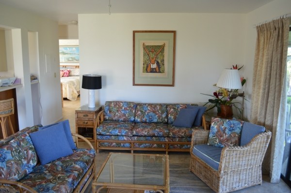 3830 Edward Road, Unit 11H Princeville, HI 96722 - Photo 11 of 14 a living room with furniture and a flat screen tv