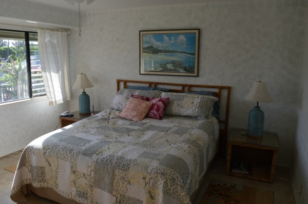 3830 Edward Road, Unit 11H Princeville, HI 96722 - Photo 13 of 14 a large bed sitting in a bedroom next to a window