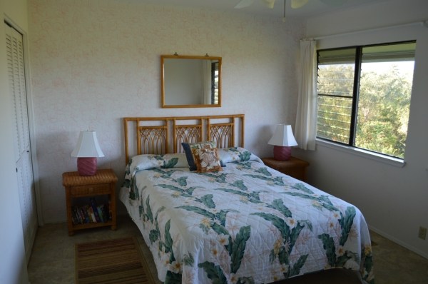 3830 Edward Road, Unit 11H Princeville, HI 96722 - Photo 14 of 14 a bedroom with a bed and a window