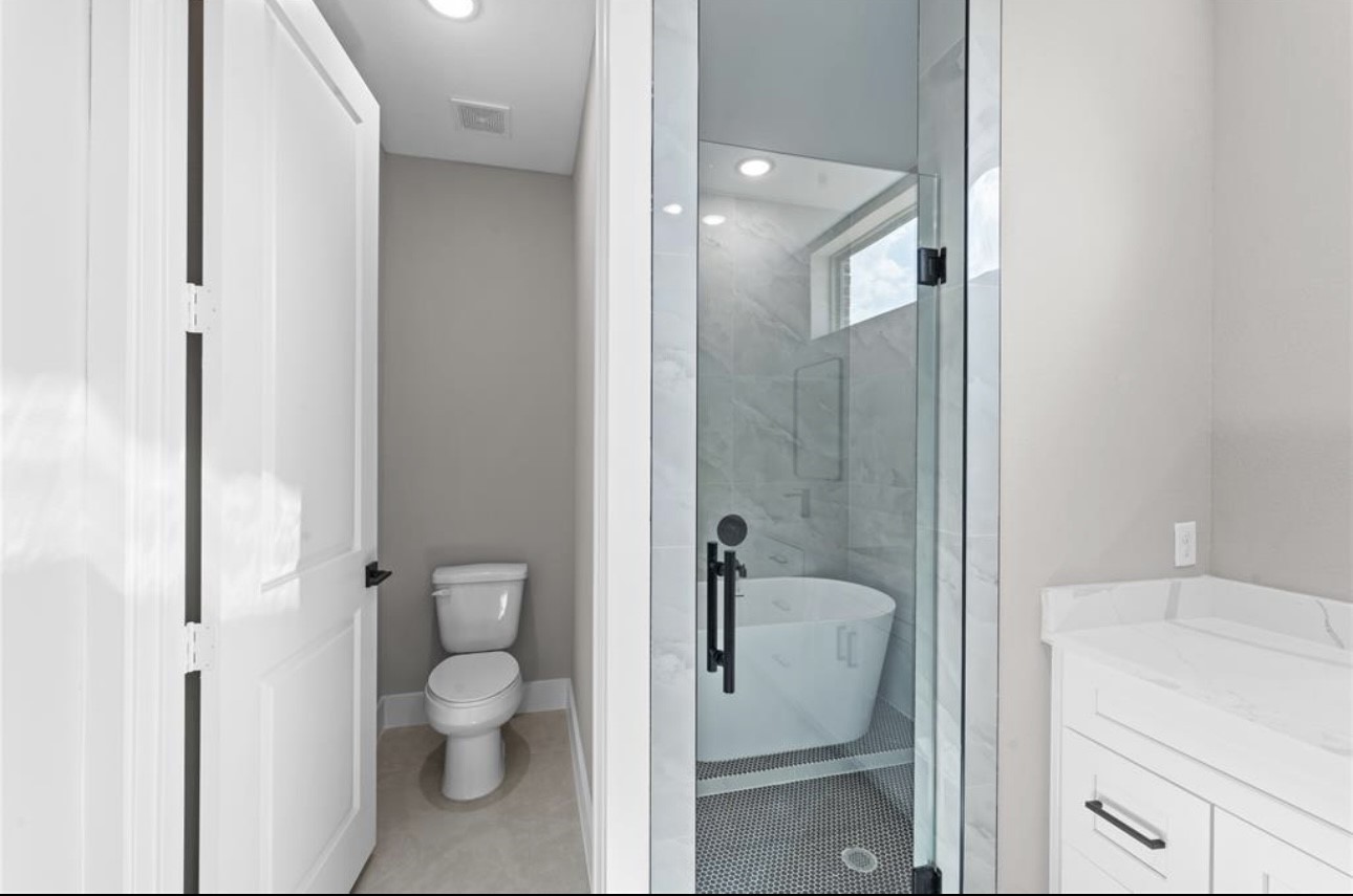 2614 Martinas Ct Spring Spring, TX 77388 - Photo 10 of 15 a bathroom with a granite countertop toilet a sink and shower