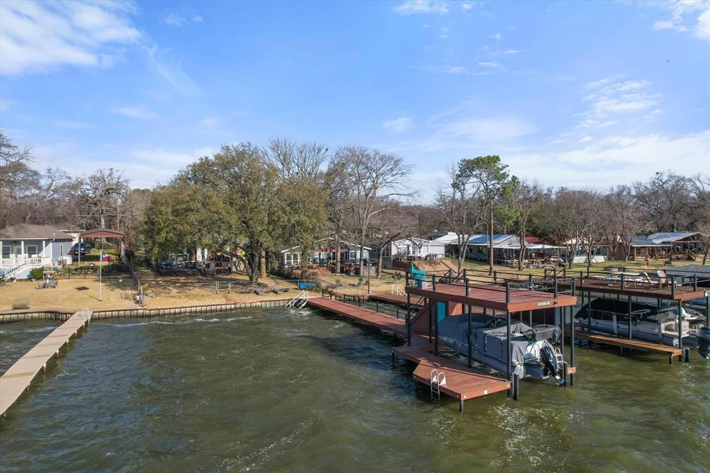 a view of a swimming pool with lawn chairs and a big yard