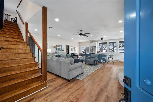 a living room with furniture and a wooden floor