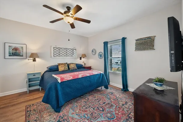 a bedroom with a bed and a chandelier