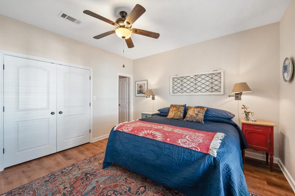 226 Palisade Loop Mabank, TX 75156 - Photo 13 of 40 a bedroom with a bed and a chandelier