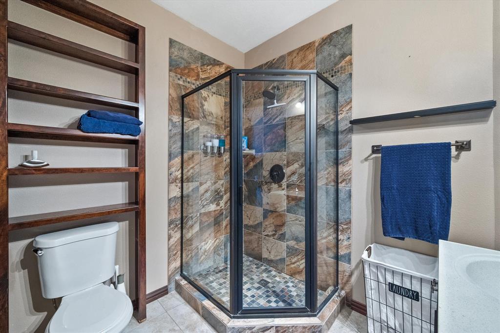226 Palisade Loop Mabank, TX 75156 - Photo 15 of 40 a bathroom with a toilet and a shower