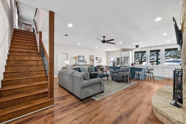 a living room with furniture and wooden floor