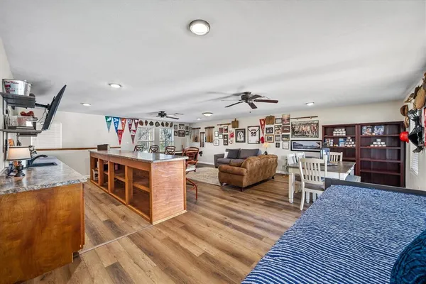 a living room with lots of furniture and clutter