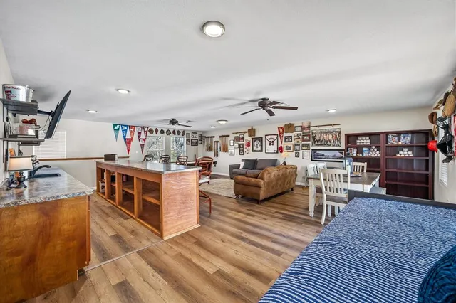 a living room with lots of furniture and clutter