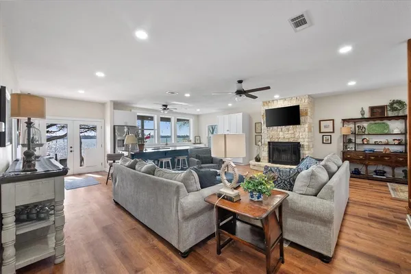 a living room with furniture a fireplace and a flat screen tv