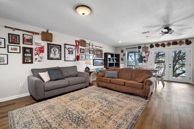 a living room with furniture and wooden floor