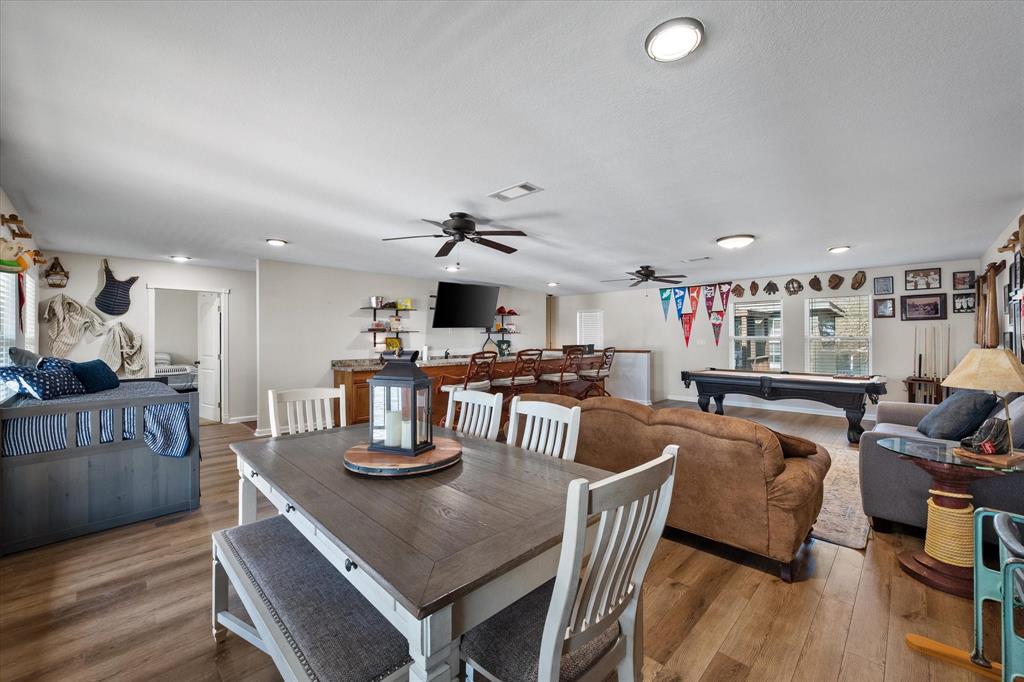 226 Palisade Loop Mabank, TX 75156 - Photo 23 of 40 a kitchen with stainless steel appliances granite countertop a dining table and chairs with wooden floor