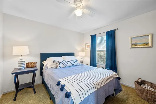 a bedroom with a bed and a lamp on table