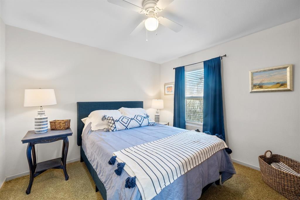 226 Palisade Loop Mabank, TX 75156 - Photo 25 of 40 a bedroom with a bed and a lamp on table